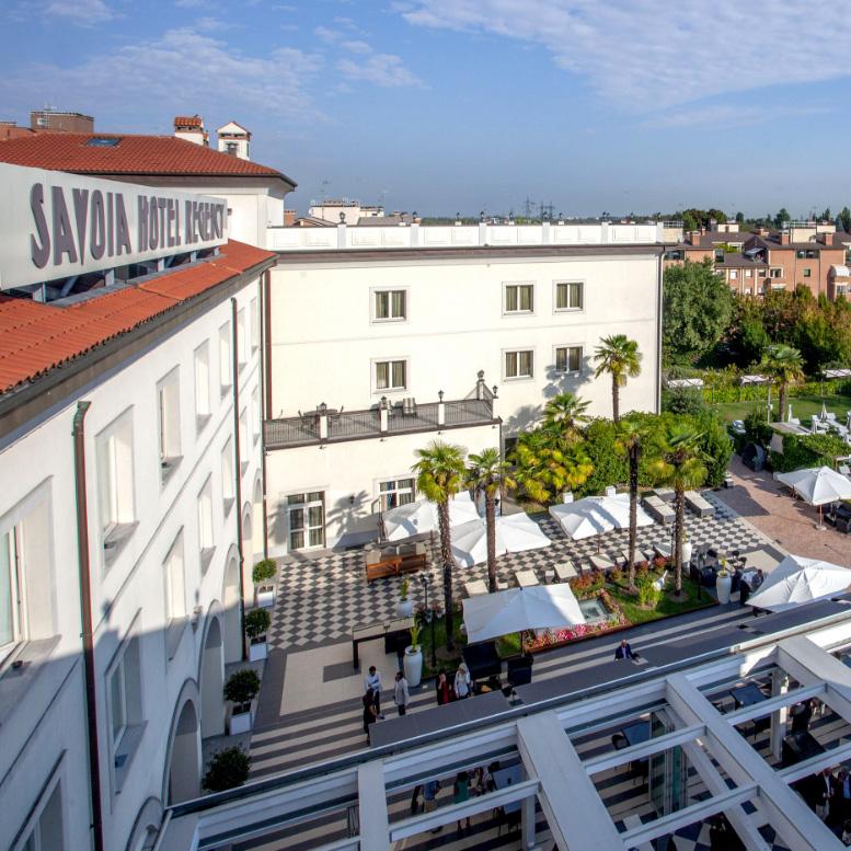 Aerial view of Savoia Hotel Regency with garden and terrace.